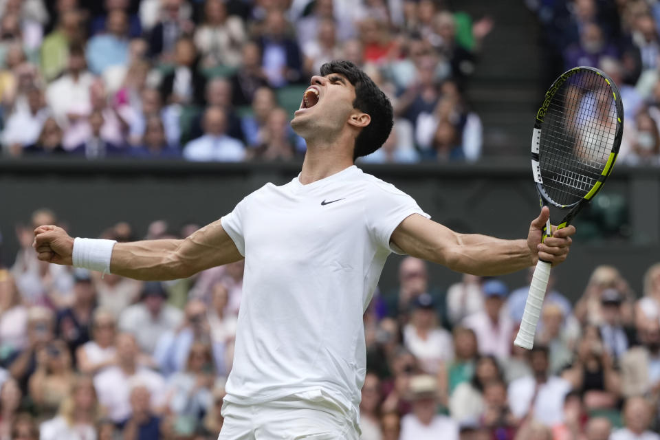 Carlos Alcaraz of Spain celebrates after defeating Daniil Medvedev of Russia in their semifinal match at the Wimbledon tennis championships in London, Friday, July 12, 2024. (AP Photo/Kirsty Wigglesworth)