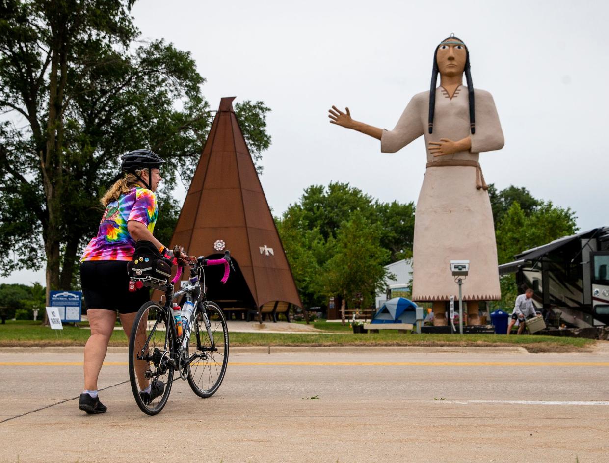 Cyclists take a closer look at giant statue of Pocahontas along the road in Pocahontas after arriving during the second day of RAGBRAI Monday, July 25, 2022.