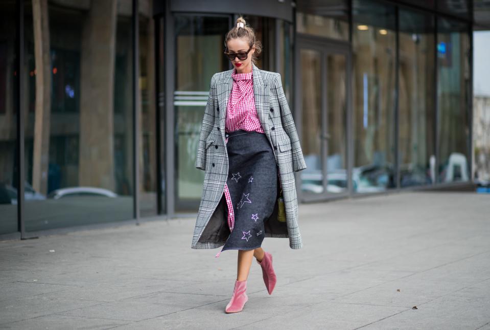 Try a denim skirt with a bright striped blouse and a tailored coat draped over your shoulders. Accessorize with vibrant velvet booties.