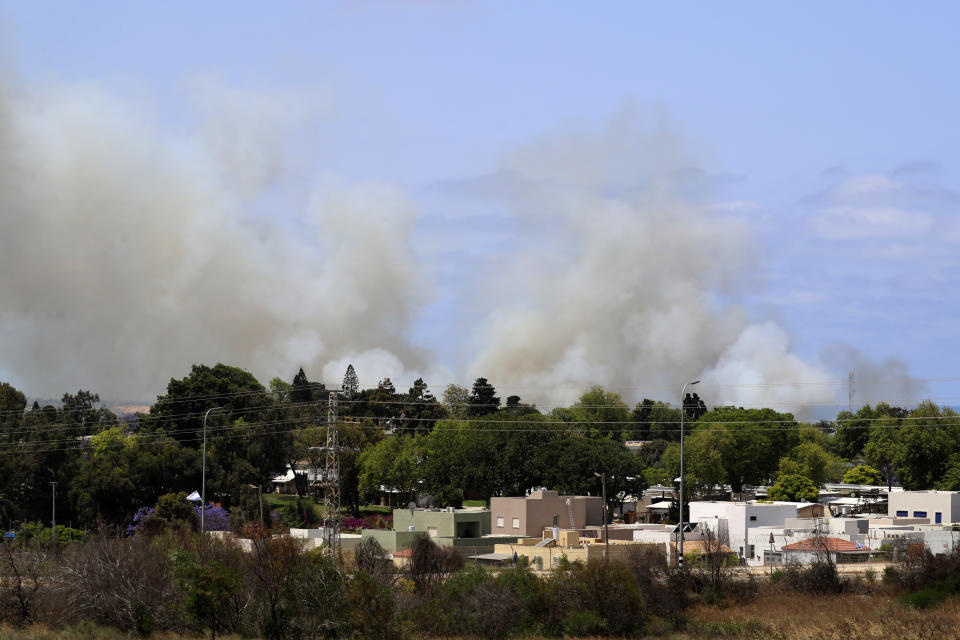 Smoke rises in a community in southern Israel after it was struck by a rocket fired from the Gaza Strip, Thursday, May 20, 2021. (AP Photo/Ariel Schalit)