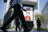 FILE - A person walks in front of the Tokyo Stock Exchange building Wednesday, Oct. 2, 2024, in Tokyo. (AP Photo/Eugene Hoshiko, File)