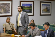 FILE - In this June 14, 2019 file photo Ex-NFL player Kellen Winslow II, standing, who was accused of committing several sex crimes against women in North County last year, including rape, answers a question from San Diego County Superior Court Vista Judge Blaine Bowman during a status hearing in Vista, Calif. Winslow could face more than a decade in prison for multiple rapes and other sexual offenses against five women in Southern California, including one who was homeless when he attacked her in 2018. Winslow will appear via video conference at the hearing Wednesday, March 3, 2021, in San Diego Superior Court. (Howard Lipin/The San Diego Union-Tribune via AP, Pool,File)