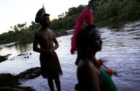 Indigenous people from the Pataxo Ha-ha-hae tribe look at Paraopeba river, after a tailings dam owned by Brazilian mining company Vale SA collapsed, in Sao Joaquim de Bicas near Brumadinho, Brazil January 28, 2019. REUTERS/Adriano Machado