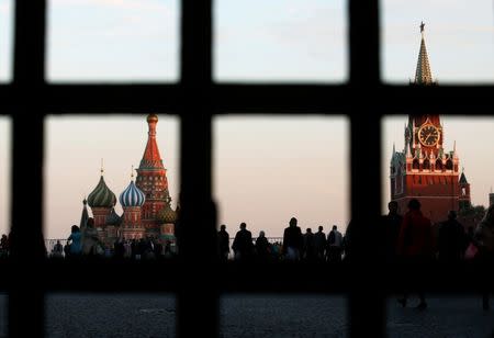 FILE PHOTO: Red Square, St. Basil's Cathedral (L) and the Spasskaya Tower of the Kremlin are seen through a gate in central Moscow, September 18, 2014. REUTERS/Maxim Zmeyev/File Photo
