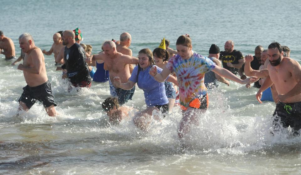 The Polar Plunge at Smuggler's Beach, a fundraiser for the Friends of Yarmouth Council on Aging, is due to take place again on New Year's Day. MERRILY CASSIDY/CAPE COD TIMES