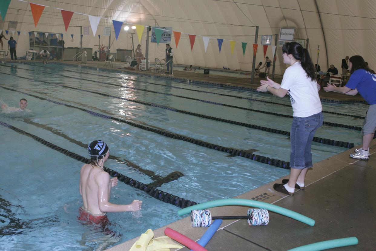 (SPORTS) - MANASQUAN - 032606 - Gina Vasseur of Wall, left, and Debbie Ruckert of Brielle, right, cheer on Sean Chetti as he swims his laps during practice for the Monmouth Coast Waves swim team at the Atlantic Club in Wall in this 2006 file photo.