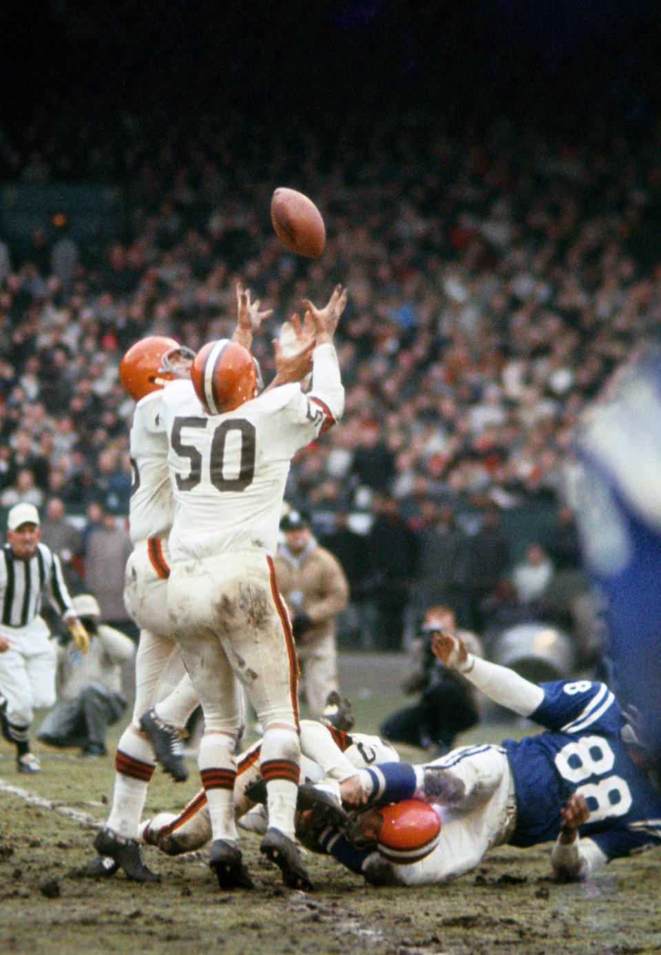 Browns linebacker Vince Costello (50) intercepts a pass from Baltimore Colts quarterback Johnny Unitas during the 1964 NFL Championship Game at Cleveland Municipal Stadium, Dec. 27, 1964. The Browns won 27-0.