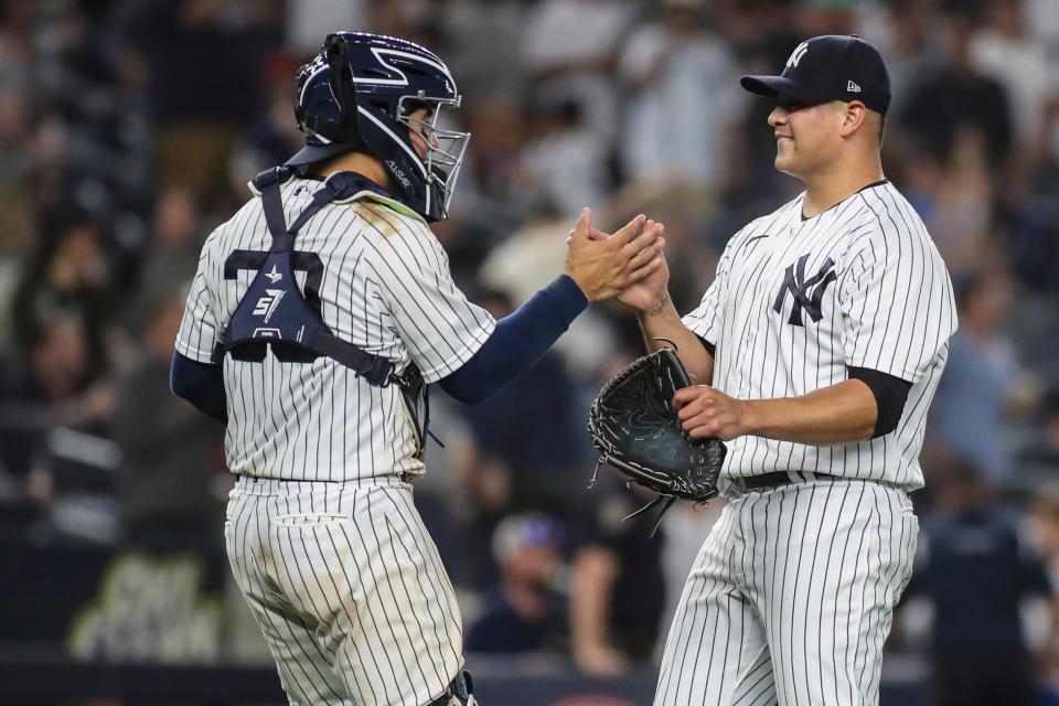 June 3, 2022; Bronx, N.Y. -- Yankees relief pitcher Manny Banuelos (68) and catcher Jose Trevino (39) congratulate each other after defeating the Detroit Tigers 13-0 at Yankee Stadium. Mandatory Credit: Wendell Cruz-USA TODAY Sports