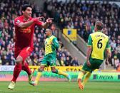 Luis Suarez (left) celebrates scoring a goal for Liverpool against Norwich City at Carrow Road on April 20, 2014