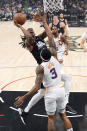 Los Angeles Clippers guard Terance Mann, left, shoots as Phoenix Suns guard Bradley Beal defends during the first half of an NBA basketball game Wednesday, April 10, 2024, in Los Angeles. (AP Photo/Mark J. Terrill)