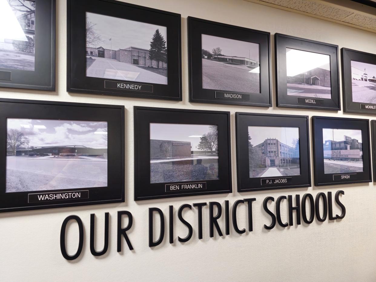 A collage of photos of Stevens Point Area Public School District school buildings is displayed in the Bliss Educational Services Center.