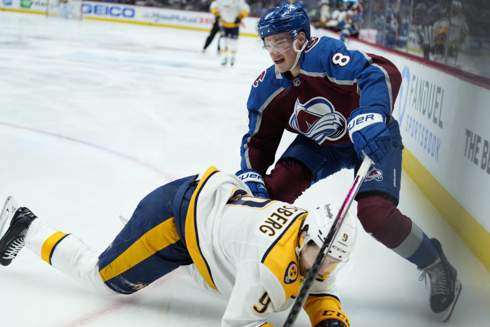 Colorado Avalanche defenseman Cale Makar (8) tangles with Nashville Predators left wing Filip Forsberg (9) during the first period in Game 2 of an NHL hockey Stanley Cup first-round playoff series Thursday, May 5, 2022, in Denver. (AP Photo/Jack Dempsey)