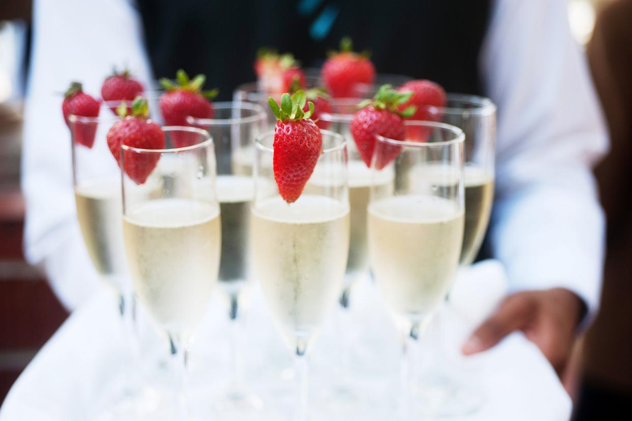 waiter serving champagne on a tray