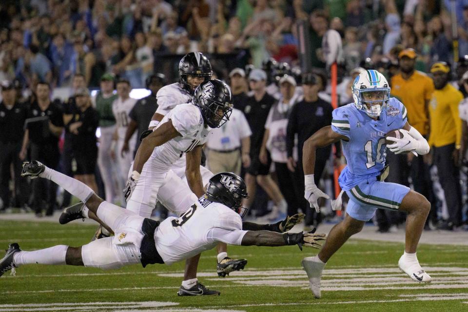 Tulane wide receiver Shae Wyatt (10) breaks free for a touchdown run against Central Florida defensive back Divaad Wilson (9) during the second half of the American Athletic Conference championship NCAA college football game in New Orleans, Saturday, Dec. 3, 2022. (AP Photo/Matthew Hinton)