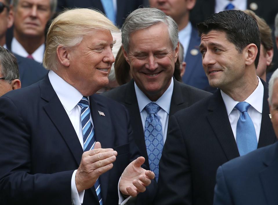 From left, President Donald Trump, Freedom Caucus Chairman Mark Meadows and House Speaker Paul Ryan celebrate after Republicans passed legislation aimed at repealing and replacing Obamacare in 2017.