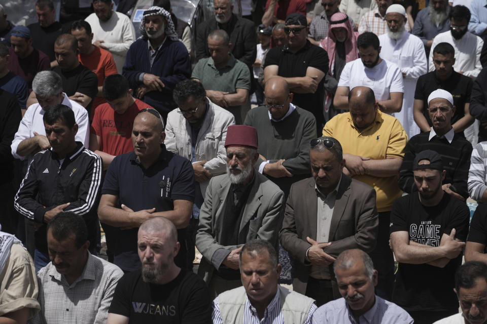 Palestinians gather for Friday prayers during the Muslim holy month of Ramadan, hours after Israeli police clashed with protesters at the Al Aqsa Mosque compound, in Jerusalem's Old City, Friday, April 22, 2022. (AP Photo/Mahmoud Illean)