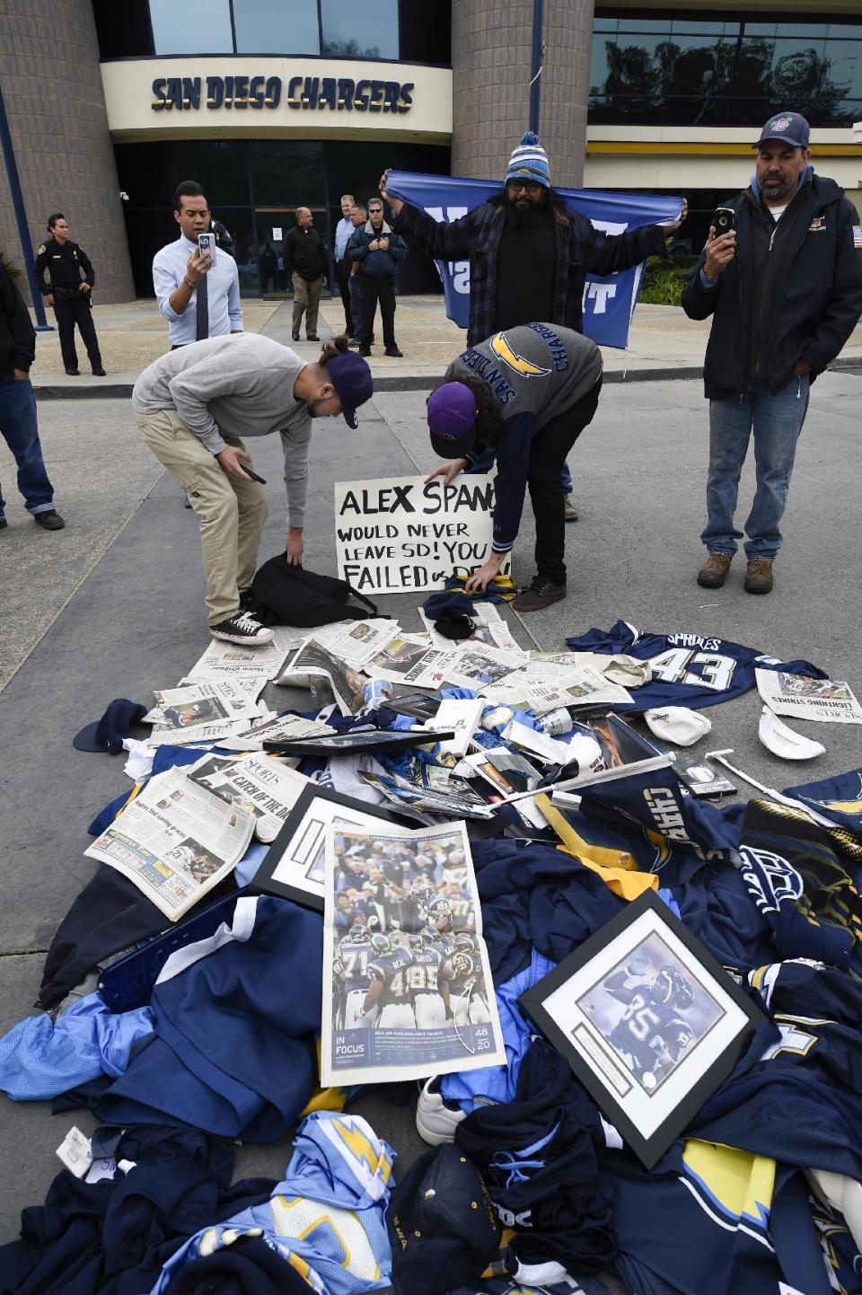 Former Chargers fans dump memorabilia in front of Chargers headquarters after the team announced that it will move to Los Angeles, Thursday Jan. 12, 2017, in San Diego. (AP Photo/Denis Poroy)