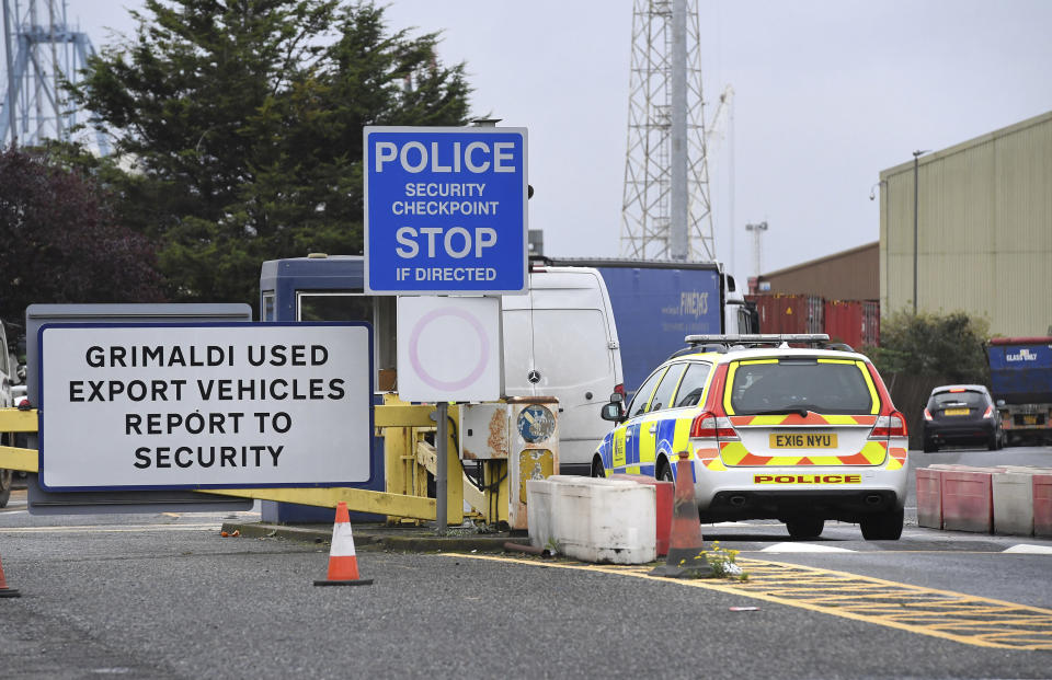 A police car enters the Port of Tilbury, where a shipping container with 39 people is thought to have entered England, near Grays, England, Friday Oct. 25, 2019. A shipping container truck was found Wednesday containing 39 lifeless bodies who are believed to be Chinese, and China called Friday for joint efforts to counter human smuggling. (Kirsty O'Connor/PA via AP)