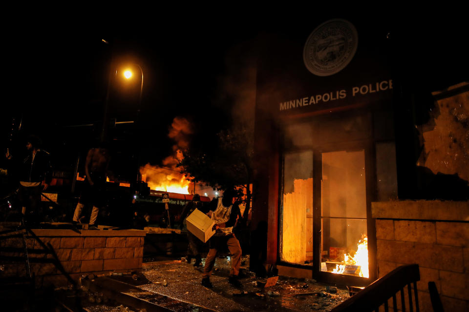 A protester sets fire to the entrance of a police station in Minneapolis. REUTERS/Carlos Barria (Photo: Carlos Barria / Reuters)