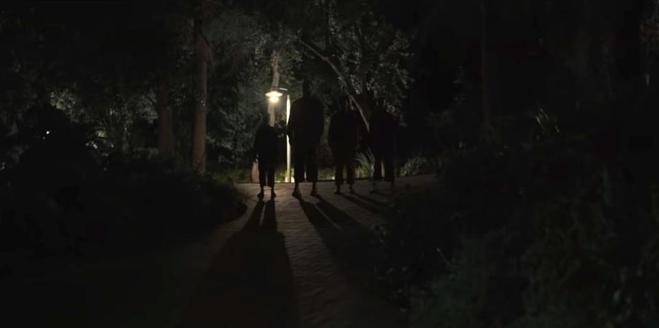 The Tethered versions of the Wilsons standing in their driveway in "Us"