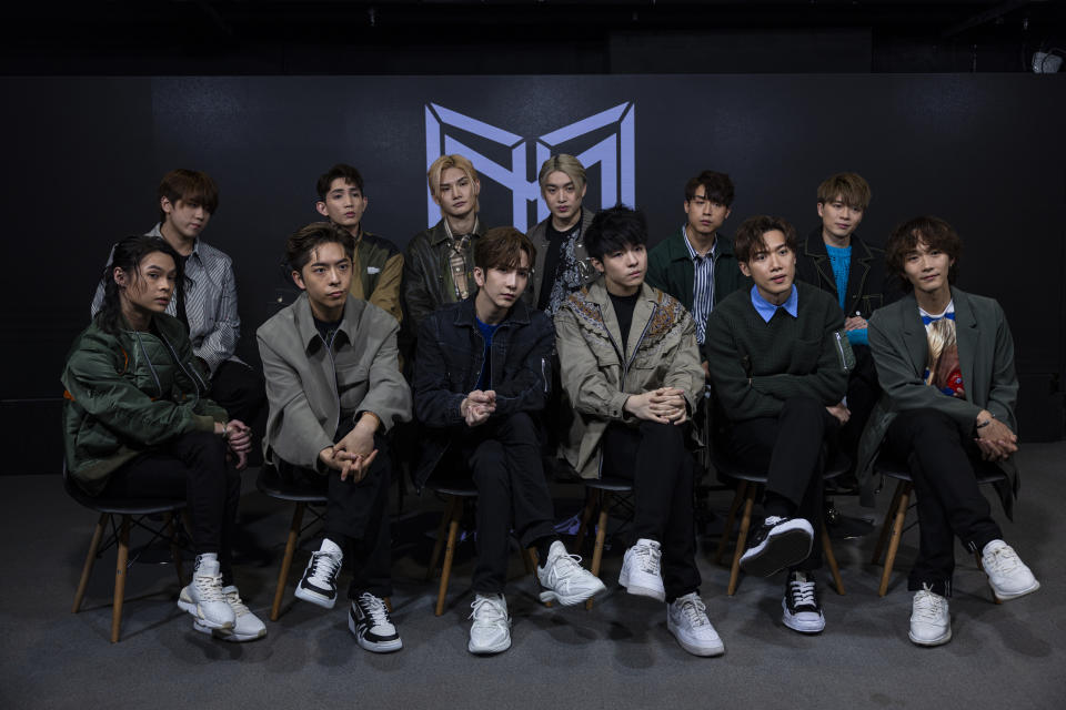 Cantopopboy bandMirror members, from top row left, Keung To, Lok Man Yeung, Jeremy Lee, Jer Lau, Anson Kong, Frankie Chan and, from bottom row left, Tiger Yau, Edan Lui, Anson Lo, Ian Chan, Stanley Yau and Alton Wong take part in an interview with The Associated Press in Hong Kong on Sunday, March 12, 2023. Hong Kong's most popular boy band Mirror, a major driving force behind the revival of the local pop music scene, launched its first English song on Friday, hoping to bring the city's tunes to music lovers globally. (AP Photo/Louise Delmotte)