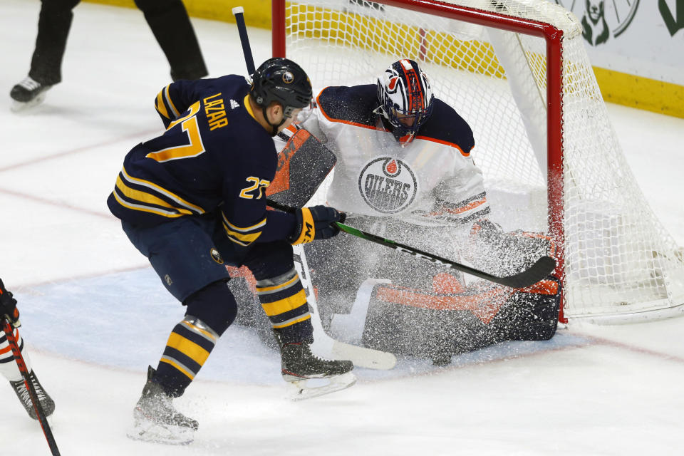 Buffalo Sabres forward Curtis Lazar (27) is stopped by Edmonton Oilers goalie Mike Smith (41) during the first period of an NHL hockey game Thursday, Jan. 2, 2020, in Buffalo, N.Y. (AP Photo/Jeffrey T. Barnes)