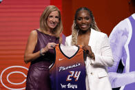 UCLA's Charisma Osborne, right, poses for a photo with WNBA commissioner Cathy Engelbert, left, after being selected 25th overall by the Phoenix Mercury during the third round of the WNBA basketball draft on Monday, April 15, 2024, in New York. (AP Photo/Adam Hunger)