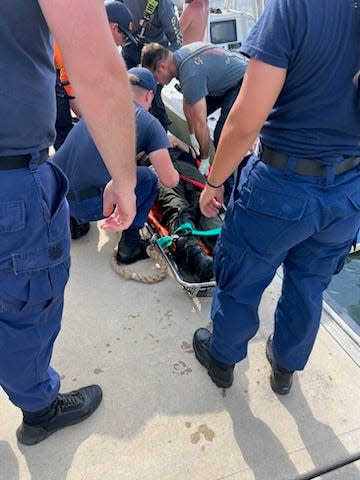Vero Beach friends Kyle Purvis, Cody King, and Brandon Keller rescue St. Lucie County Deputy Ryan Betsinger from the Indian River Lagoon on Wednesday, April 17, 2024. Betsinger was thrown overboard and injured when his boat hit a large wave.