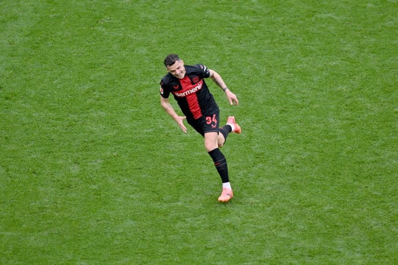 Leverkusen's Granit Xhaka celebrates scoring his side's second goal during the German Bundesliga soccer match between Bayer 04 Leverkusen and SV Werder Bremen at BayArena. David Inderlied/dpa