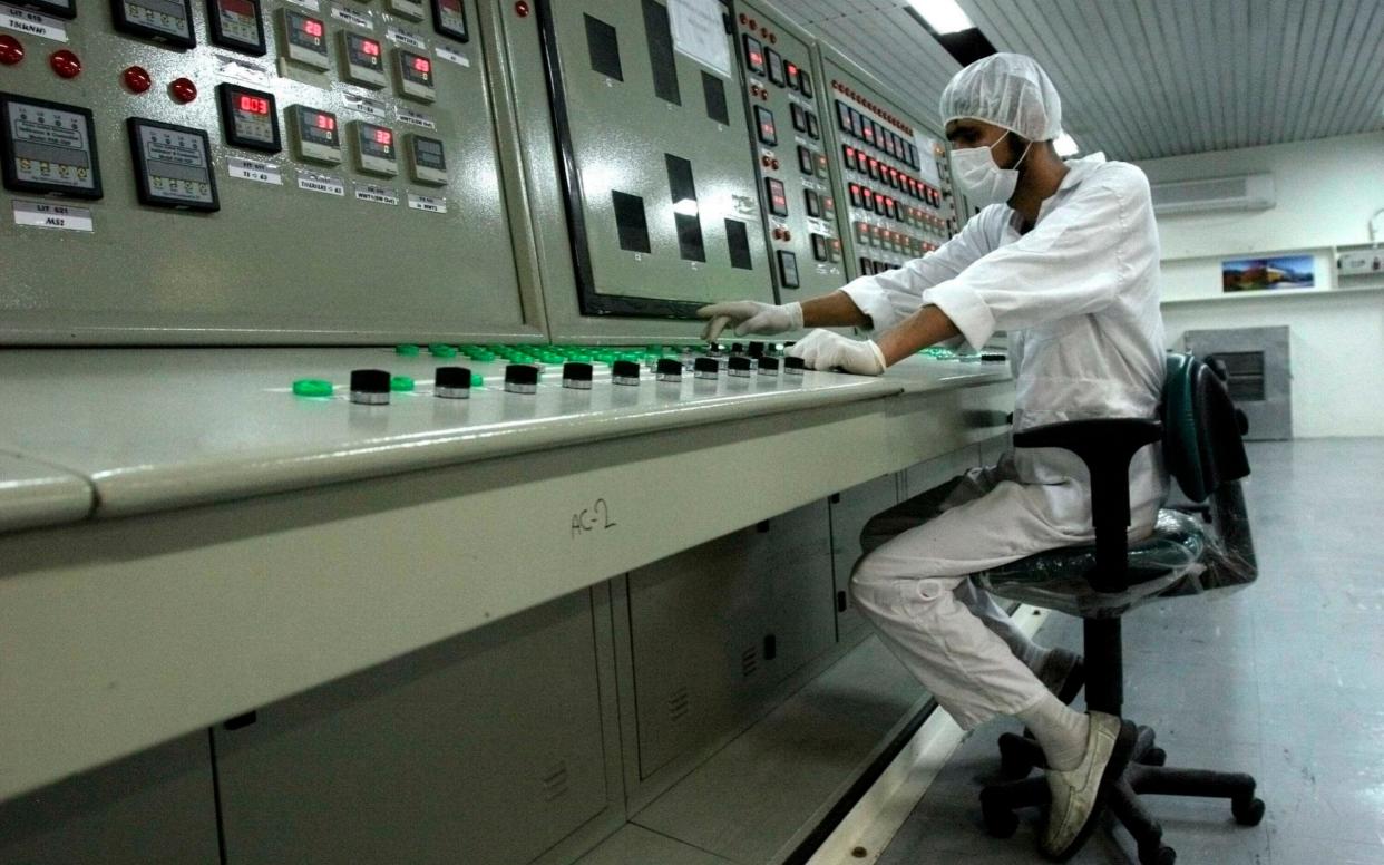 An Iranian technician working at the Uranium Conversion Facility just outside the city of Isfahan in 2007 - AP