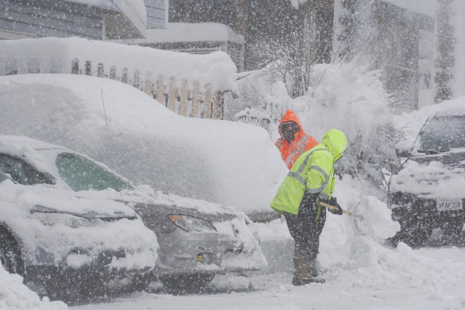 Workers clear snow in a residential neighborhood, Saturday, March 2, 2024, in Truckee, Calif. (AP Photo/Brooke Hess-Homeier)