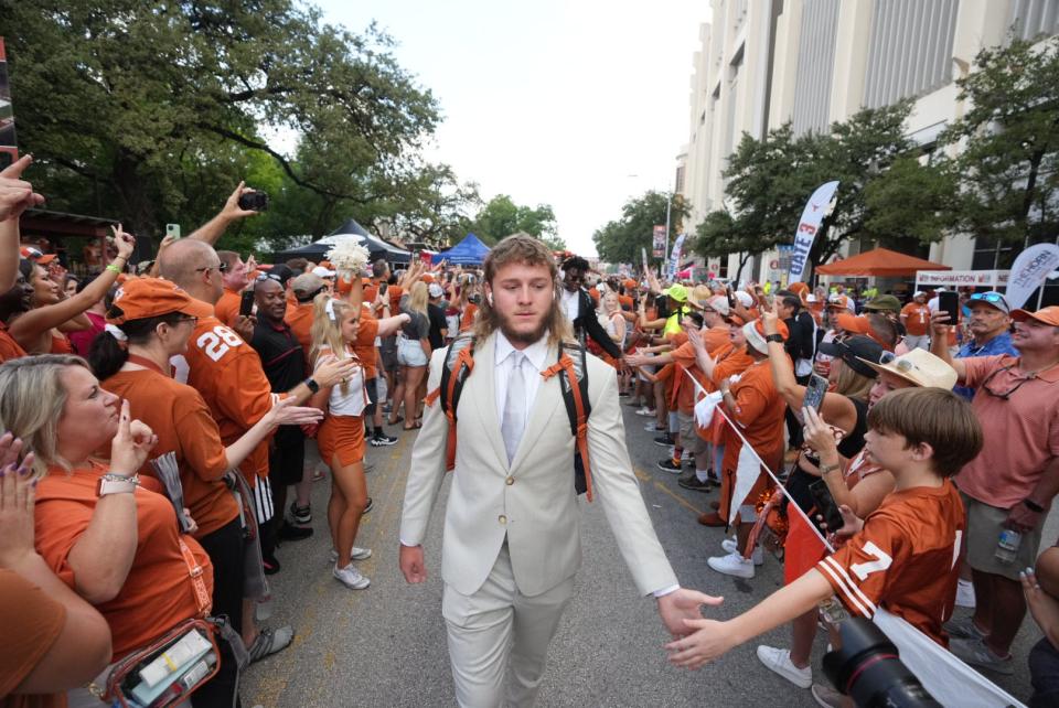 Texas quarterback Quinn Ewers arrives at Royal-Memorial Stadium ahead of the Alabama game Sept. 10. Late in the first quarter he suffered a sprained clavicle, and he has missed the last two games. But he is practicing again, and there's a chance he'll play this week.