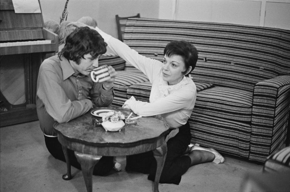<p><em>The Wizard of Oz</em> star Judy Garland and musician Mickey Deans enjoy a cup of tea on the floor of their London home the morning of their wedding, March 15, 1969.</p>