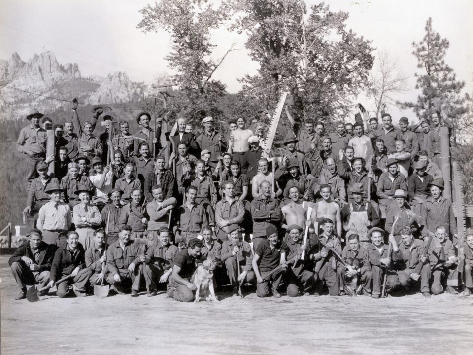 A black and white group photo of the men enrolled with the CCC.