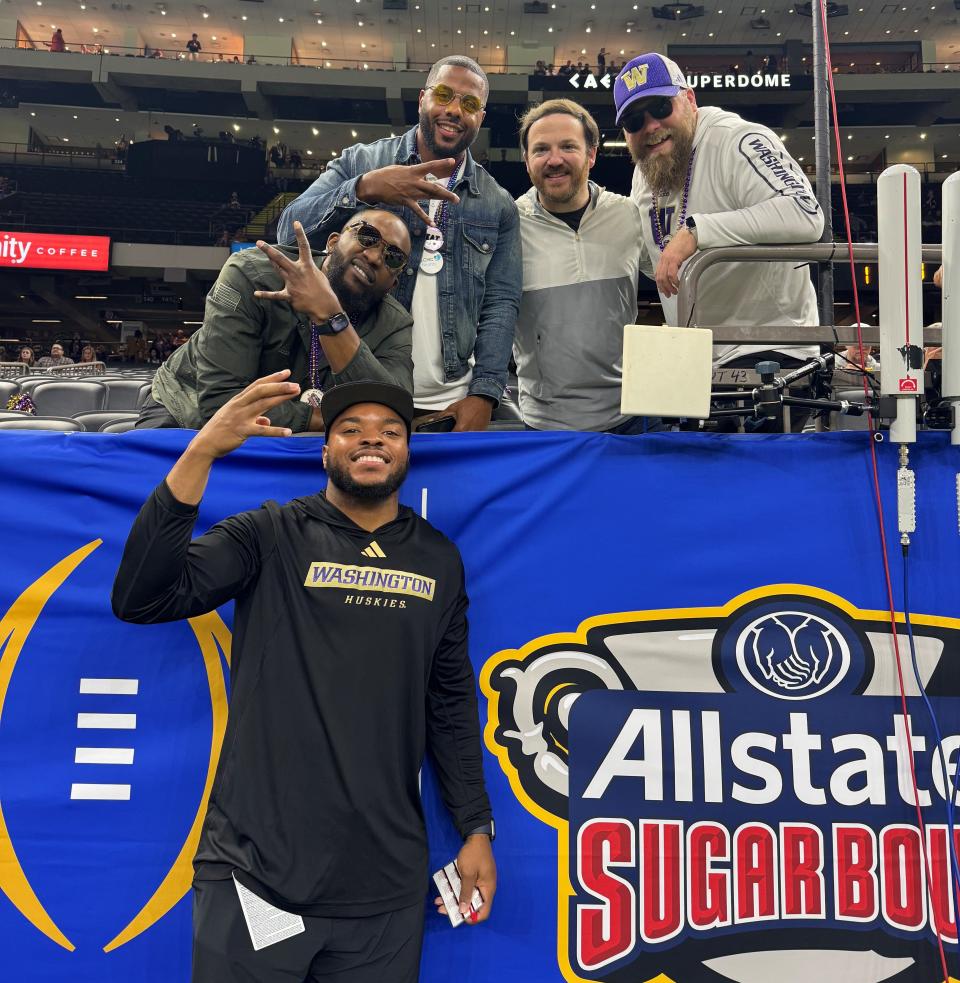 South Bend Adams alum Shaq Vann, left, takes a photo with friends and family following the Sugar Bowl. Vann is an assistant coach for Washington, which won the game to advance to the national championship Monday against Michigan.