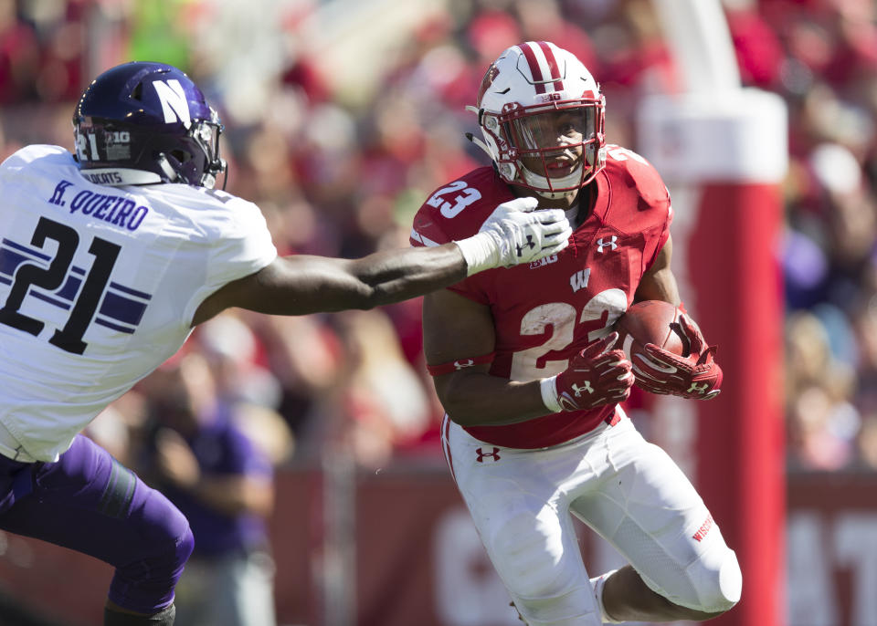 Sept. 30, 2017; Madison; Wisconsin Badgers running back Jonathan Taylor (23) rushes with the football as Northwestern Wildcats safety Kyle Queiro (21) defends during the fourth quarter at Camp Randall Stadium. Jeff Hanisch-USA TODAY Sports