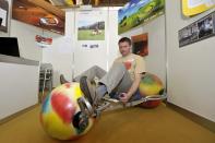 Germany's Ulli Boehme sits on the colourful Bail Rider - a new sport and leisure machine that replaces wheels with balls.