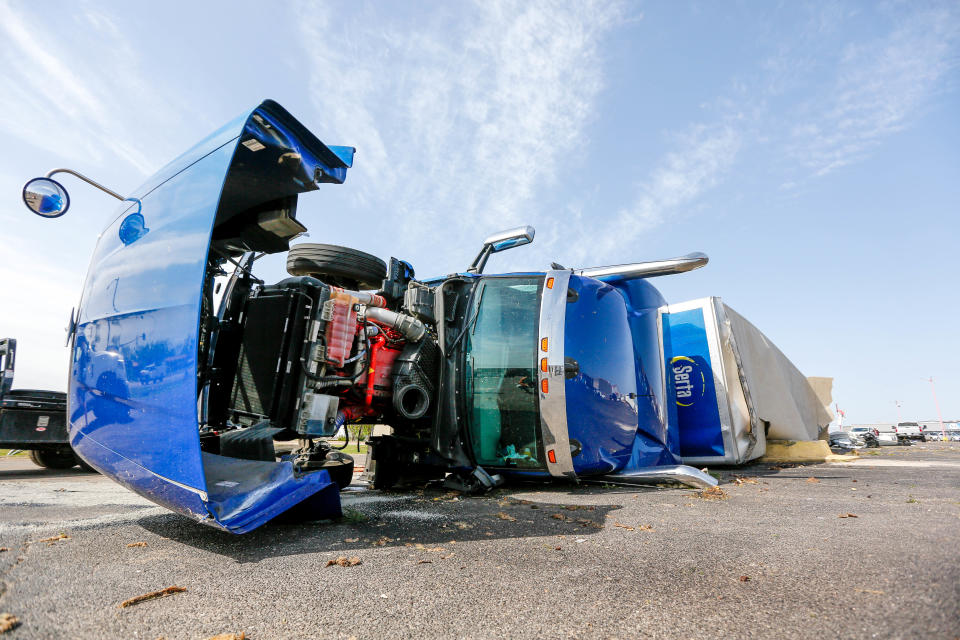 Semi-trucks sit on their sides on Thursday after a storm hit Shawnee Okla., on Wednesday, April 19, 2023.