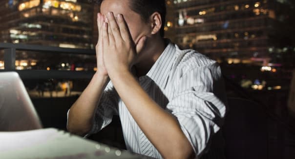 Chinese businessman working at desk at night