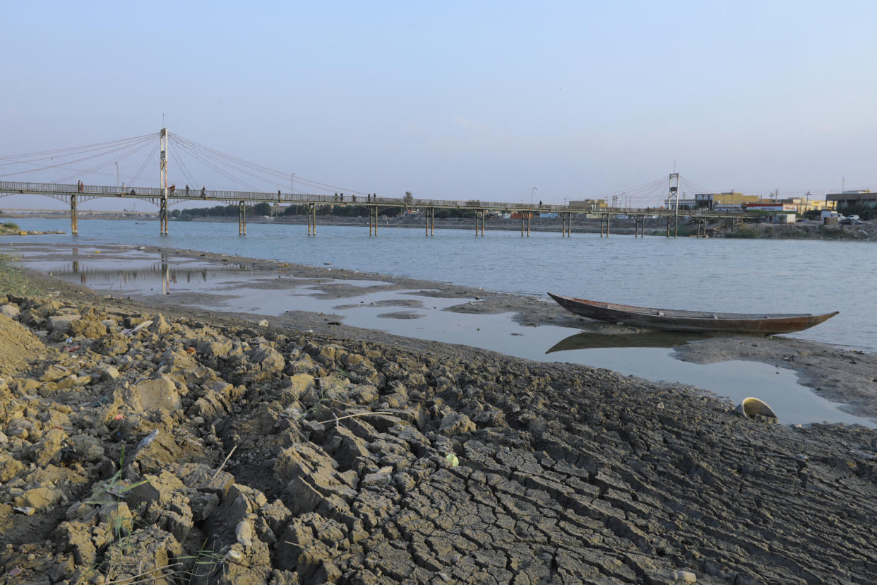 An abandoned boat lies on a sand bank due to a drought-induced drop in the water levels of the Euphrates River 