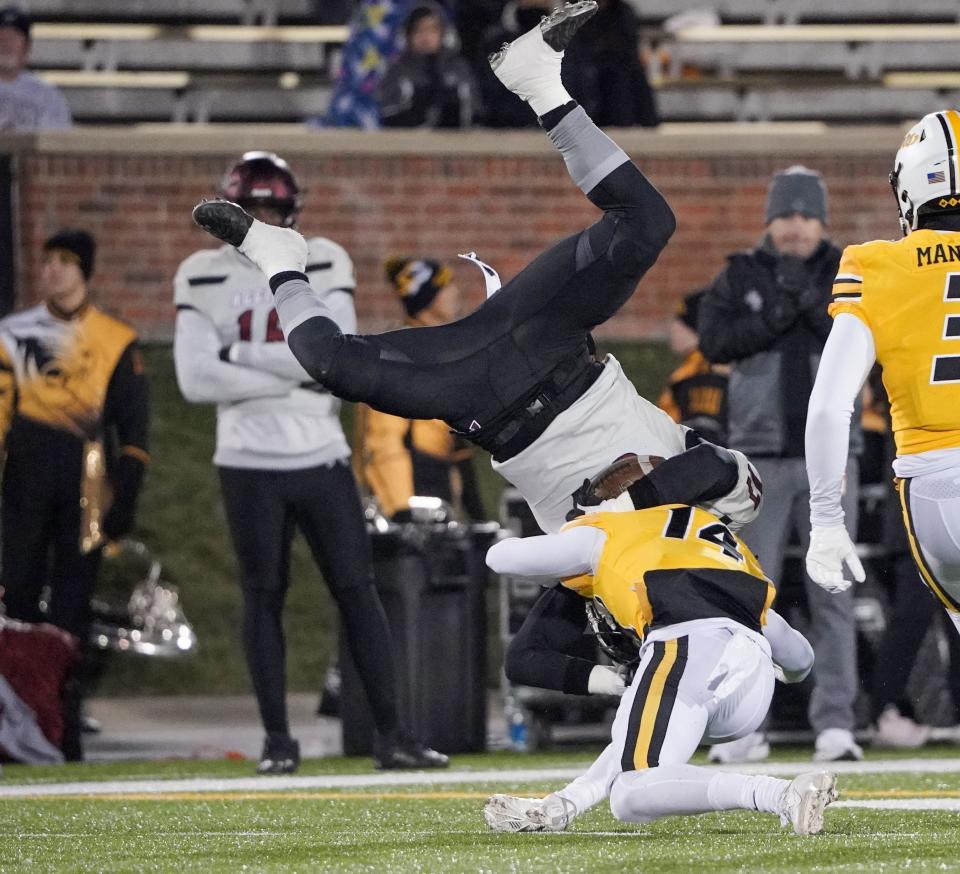 Nov 19, 2022; Columbia, Missouri, USA; Missouri Tigers defensive back Kris Abrams-Draine (14) tackles New Mexico State Aggies quarterback Weston Eget (17) during the first half at Faurot Field at Memorial Stadium.