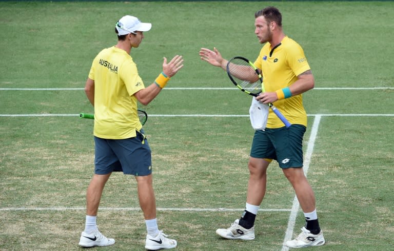 Australia's John Peers (L) and Sam Groth celebrate their win against Slovakia's Andrej Martin and Igor Zelenay in the Davis Cup play-off in Sydney on September 17, 2016