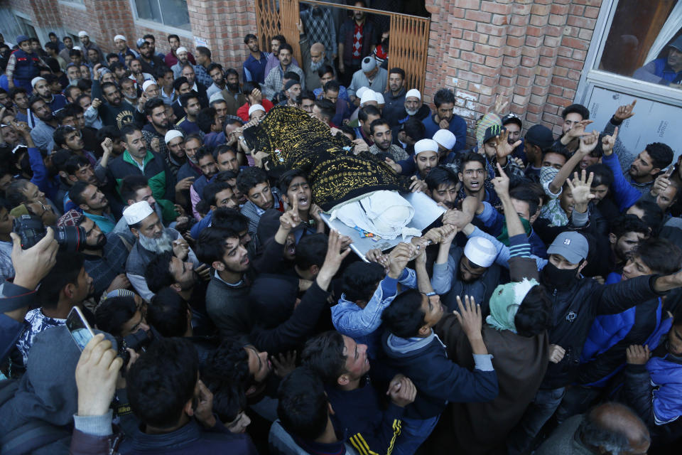 Kashmiri villagers carry the body of Uzair Mushtaq during his funeral in Kulgam 75 Kilometers south of Srinagar, Indian controlled Kashmir, Sunday, Oct. 21, 2018. Three local rebels were killed in a gunbattle with Indian government forces in disputed Kashmir on Sunday, and six civilians were killed in an explosion at the site after the fighting was over, officials and residents said. (AP Photo/Mukhtar Khan)