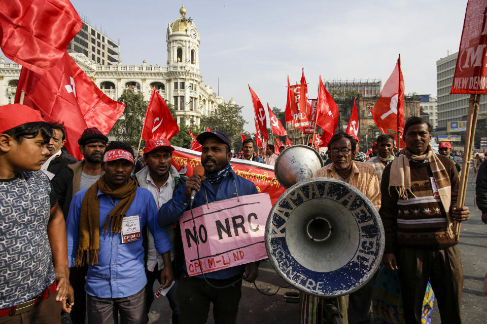 Activists of the Communist Party of India (Marxist-Leninist) and alliance march in a protest rally against the Citizenship Amendment Act, in Kolkata, India, Saturday, Dec. 21, 2019. Critics have slammed the law as a violation of India's secular constitution and have called it the latest effort by the Narendra Modi government to marginalize the country's 200 million Muslims. Modi has defended the law as a humanitarian gesture. Banner reads, withdraw CAA and NRC bills, join the rally and meeting. (AP Photo/Bikas Das)