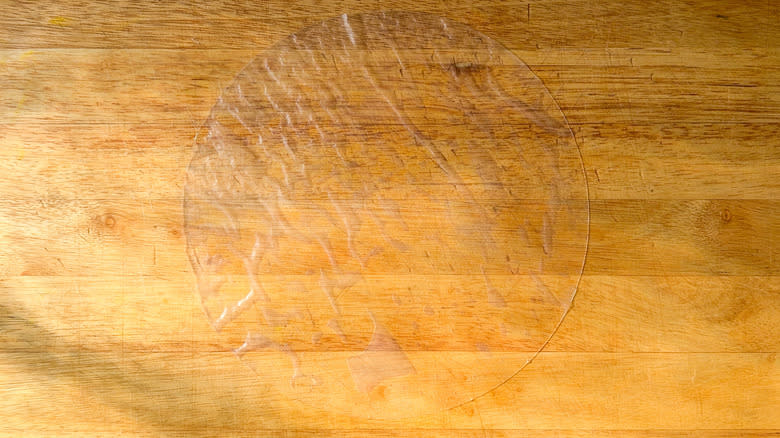 Softened rice paper wrapper on cutting board