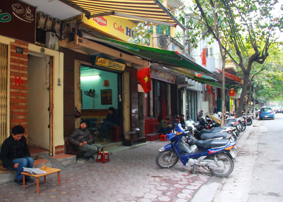 In this photo taken Jan. 5, 2013, customers drink coffee on Trieu Viet Vuong Street in Hanoi, Vietnam. Starbucks announced Thursday, Jan. 3, it would enter Vietnam in early February with a cafe in Ho Chi Minh City. But the Seattle-based company faces a unique market in Vietnam, where French-inspired coffee culture reigns supreme; two homegrown chains have established presences; and family-run sidewalk cafes are as ubiquitous as noodle shops. (AP Photo/Mike Ives)