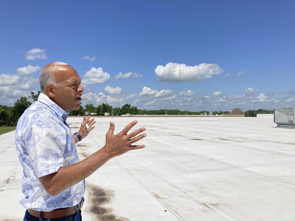 In this photo taken on June 6, 2022, Neil Bernard, pastor of New Wine Christian Fellowship in LaPlace, La., gestures to where solar panels will be installed on the roof of part of his church. (AP Photo/Rebecca Santana)