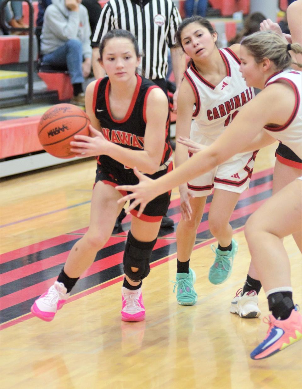 Onaway junior guard Charlotte Box (left) drives against the JoBurg defense during a girls basketball game in Johannesburg on Monday.