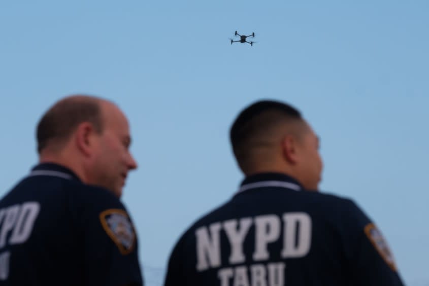 NYPD officers watch a drone in Queens, New York City. 