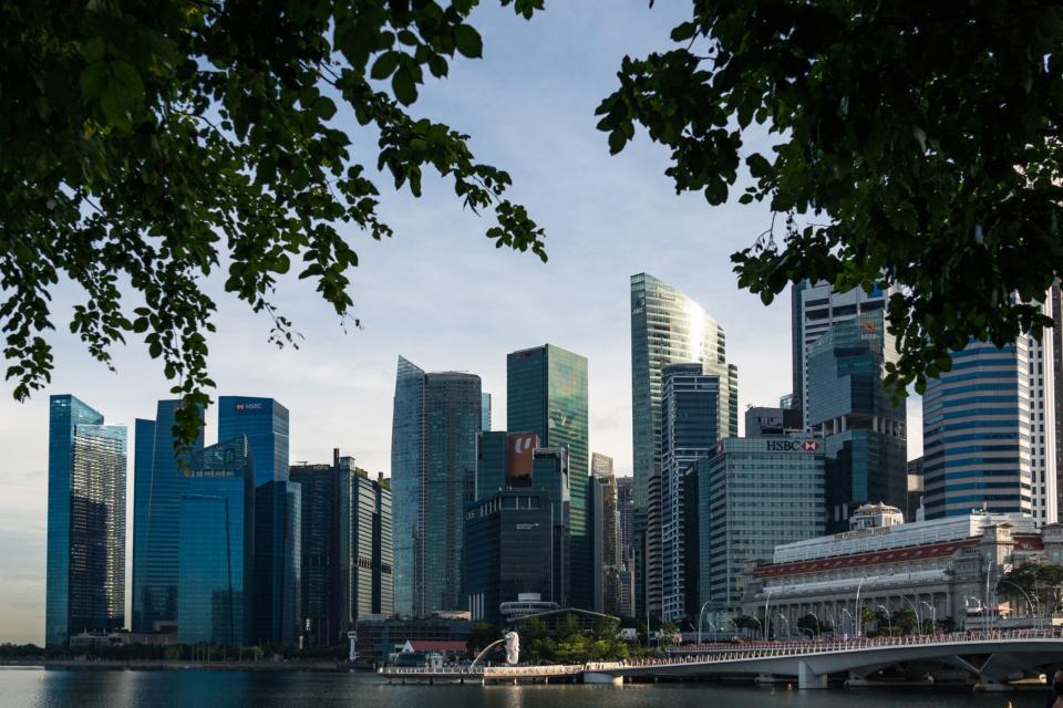 The Merlion Statue and Jubilee Bridge stand in front of the city skyline during the 